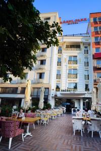 a hotel with tables and chairs in front of a building at Babel Park Hotel in Istanbul