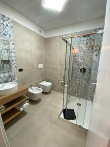 a bathroom with a shower and a toilet and a sink at Live and Love Italy in Monopoli +53 photos