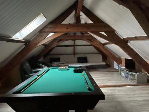 a room with a pool table in a attic at Logement entier près de Mauleon.8/10 personnes in Mauléon