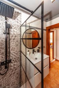 a bathroom with a sink and a mirror at Luxury Suite Ocean Views in Tías