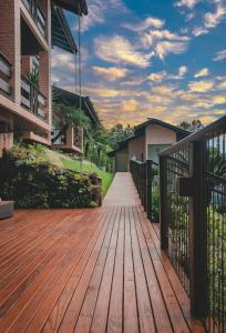 a wooden deck with a fence on a house at Village Du Lac Hotel in Pomerode +60 photos