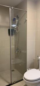 a bathroom with a glass shower with a toilet at Homestay 9view thủ Đức in Ho Chi Minh City