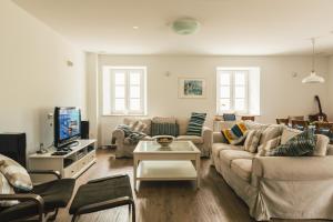 a living room with a couch and a tv at Villa Kanedolo in Momjan