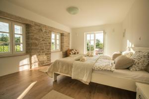 a bedroom with a large bed in a room with windows at Villa Kanedolo in Momjan +47 photos