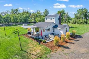 an aerial view of a white house with a grill at The Ahtanum Cottage - hot tub and views in Yakima