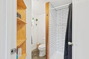 a bathroom with a toilet and a shower at The Ahtanum Cottage - hot tub and views in Yakima +20 photos