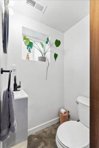 a bathroom with a white toilet and a sink at The Ahtanum Cottage - hot tub and views in Yakima