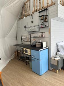 a kitchen with a blue island in a tent at Dorna Iglu Luxury Glamping Resort in Dorna Cîndrenilor