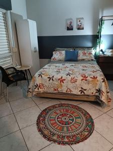 a bedroom with a bed and a rug on the floor at Apezinho 209 in São Leopoldo