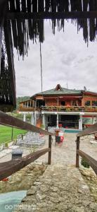 a building with tables and chairs in front of it at Restoran Domaćin in Bosanski Novi