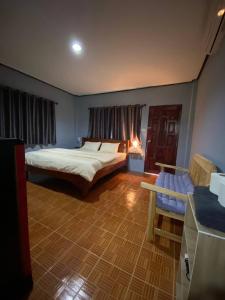 um quarto com uma cama e um sofá em KANNIKA RESORT em Ko Chang