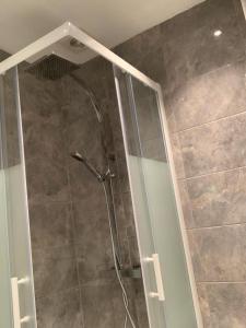 a shower with a glass door in a bathroom at Luxury Living Manchester in Manchester