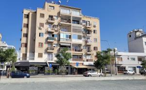 a tall building with cars parked in front of it at Modern Cityscape Home in Nicosia