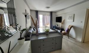 a living room with a cabinet with plants in it at Modern Cityscape Home in Nicosia