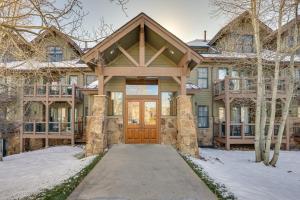 a house with a wooden door in the snow at Condo with King Bed 3 Mi to Breckenridge Gondola! in Breckenridge