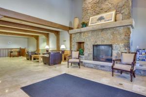 a living room with a large stone fireplace at Condo with King Bed 3 Mi to Breckenridge Gondola! in Breckenridge