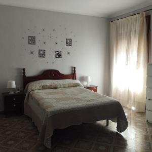 a bedroom with a bed and a window with stars on the wall at Villa 365 in La Rábita