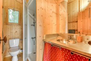 y baño con aseo y lavamanos. en Camping LA SERRE en Aigues-Vives