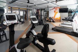 a gym with two treadmills and exercise bikes at Riu Caribe - All Inclusive in Cancún