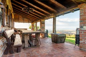 an outdoor patio with a wooden table and chairs at Kuća sreće Veronika in Nova Gradiška