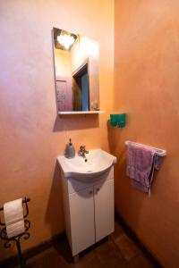 a bathroom with a white sink and a mirror at Kuća sreće Veronika in Nova Gradiška