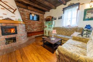 a living room with a couch and a fireplace at Kuća sreće Veronika in Nova Gradiška