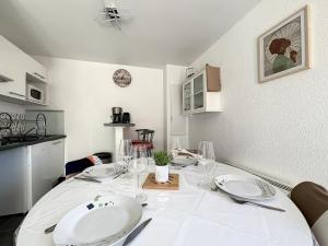 a dining room with a white table with glasses on it at Les Rêves du Crotoy in Le Crotoy