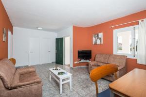 a living room with two couches and a tv at Villa Patri in Cala'n Porter