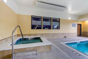 a bathroom with a hot tub and a swimming pool at Comfort Inn in Missoula