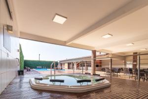 an indoor swimming pool in a house with a patio at Luz Hotel by Castelo Itaipava in Foz do Iguaçu