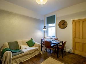 a living room with a couch and a table at Pass the Keys Hazelwood - Jesmond Cosy Flat in a Jesmond in Gosforth