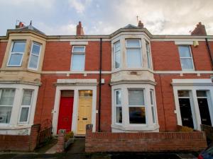 a red brick house with a red door at Pass the Keys Hazelwood - Jesmond Cosy Flat in a Jesmond in Gosforth