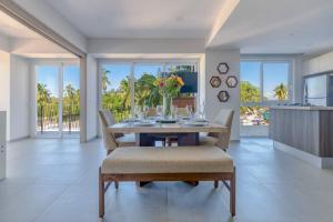 a dining room with a table and chairs at Apt w/2 beds - Private Balcony - Infinity Pool in Puerto Vallarta