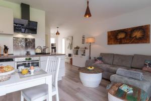 a kitchen and living room with a couch and a table at Ferienwohnung Kleine Auszeit in Graal-Müritz