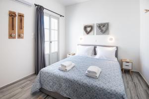a bedroom with a bed with two towels on it at Navi B3 Brand New studio in Naousa in Naousa