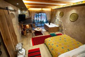 a bedroom with a tub and a bed and a sink at Vila Eden Boutique Hotel in Korçë