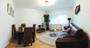 a living room with a couch and a table at Sunny Apartment in Kragujevac