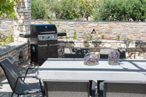 a picnic table with a grill and two jars on it at Navi B3 Brand New studio in Naousa in Naousa