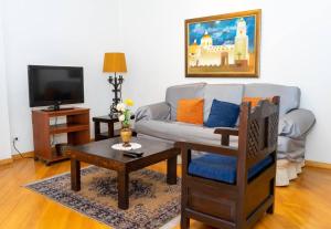 a living room with a couch and a table at Colonial Charm. Experience historic Quito. in Quito