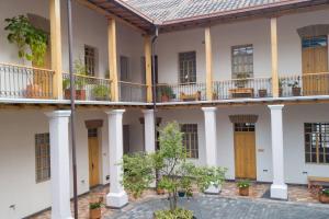 a building with wooden doors and a courtyard at Colonial Charm. Experience historic Quito. in Quito