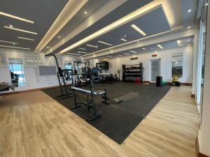 a gym with treadmills and machines in a room at Diplomatic Short Stay in Gigiri in Nairobi