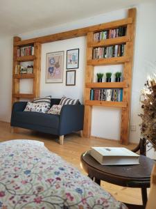 a living room with a couch and book shelves at Chata Kolmanovci in Oščadnica +53 photos