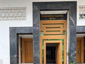 a building with two doors and a sign on it at home & room center of rabat in Rabat