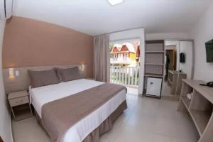 une chambre avec un grand lit et une grande fenêtre dans l'établissement Hotel Fazenda China Park, à Domingos Martins 15 autres photos