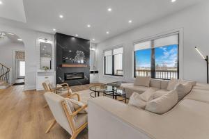 a living room with a couch and a fireplace at Sherkston Oasis - Hot Tub Soaks & Luxurious Escape in Port Colborne +50 photos