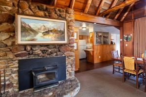 a fireplace in a living room with a stone wall at Tahquitz Pines Retreat in Idyllwild