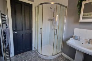 a bathroom with a shower and a sink at Westland Retreat - Magherafelt - Mid Ulster - NITB Approved in Magherafelt