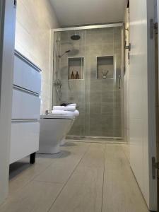 a bathroom with a shower and a toilet and a sink at Balcon San Rafael in Córdoba
