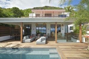 a house with a swimming pool in front of a house at Villa Nagabaaja in Saint Barthelemy