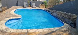 a swimming pool with blue water in a backyard at SapphireB@54 in Windhoek